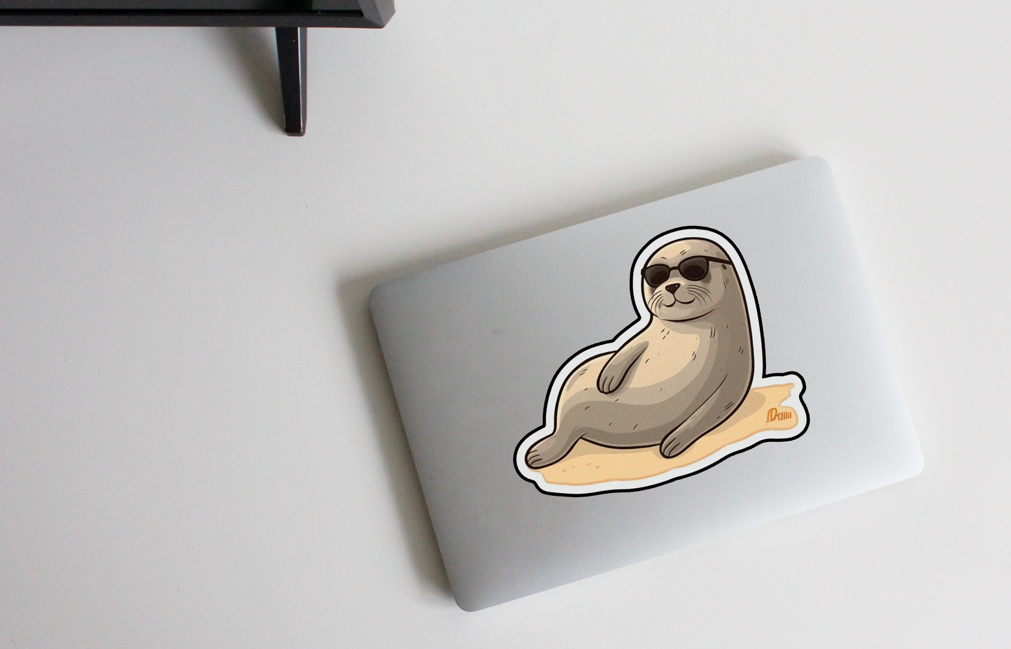 Relax in style with our 'Seaside Bliss' sticker | Enjoy the sunny vibes of a seal sunbathing on the beach!